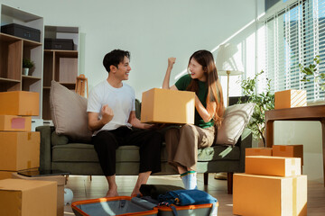 young couple helps put things in boxes and prepares to move to a new house.