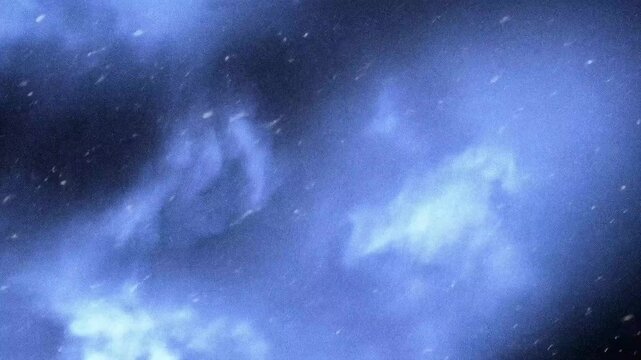 A cloudy blue sky with swirling textures, creating a mysterious and atmospheric effect.