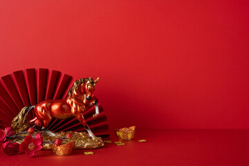 Side view, a festive Chinese New Year display featuring a golden horse, gold ingots, red fan and...