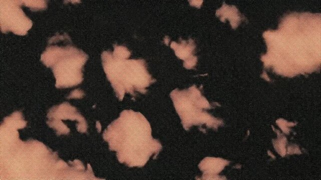A dark, abstract background featuring soft, cloudy shapes in shades of peach and brown.