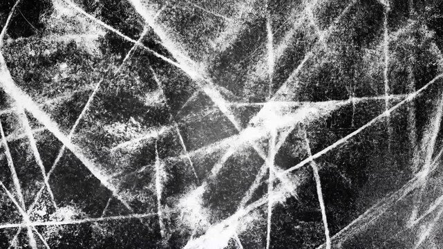 Abstract black and white texture with intersecting lines creating a chaotic pattern.