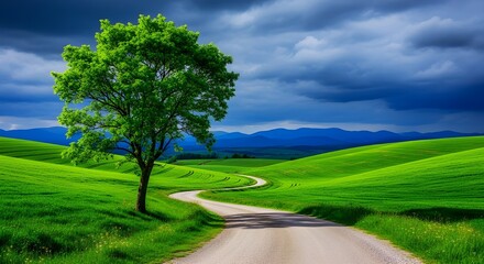 Scenic landscape of rolling green hills with a winding road and dramatic sky in the countryside