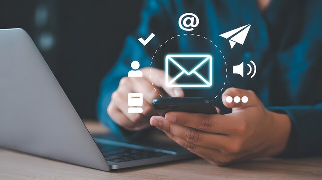 Businessman holding smartphone with floating email and communication icons, online messaging, digital marketing, email technology and network concept