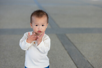 Happy baby clapping hands with joyful expression