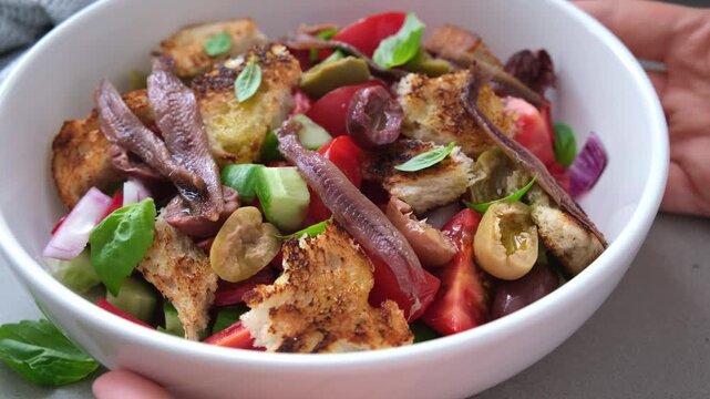 Italian panzanella with anchovies, olives and tomatoes.