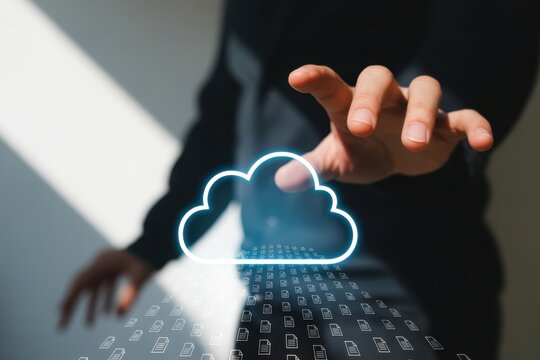 A person reaching for a glowing cloud icon above a stream of data, symbolizing cloud computing, data storage, and the digital transformation of business and technology