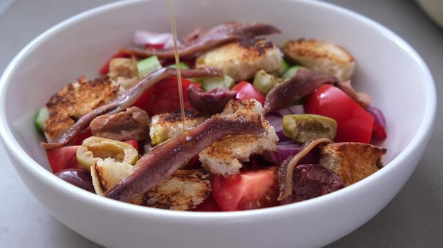 Italian panzanella with anchovies, olives and tomatoes.