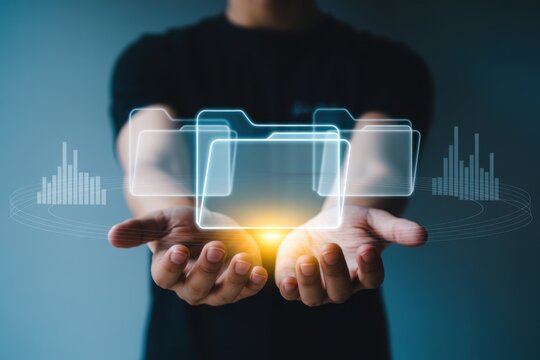 A man is holding virtual folders with glowing light, representing data management, file organization, and efficient document workflow in the digital age