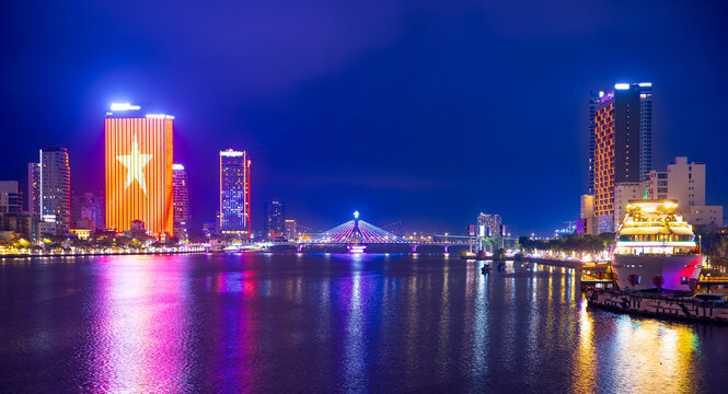 Nighttime skyline of Da nang with illuminated skyscrapers and han river - Powered by Adobe