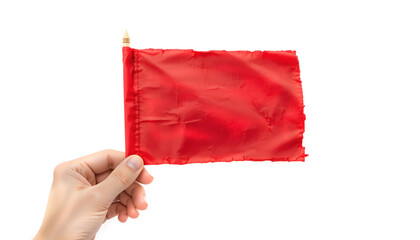 Hand holding a vibrant red flag made of textured fabric, symbolizing warning or alert, against a clean white background with ample copy space for design purposes