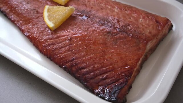 Christmas salmon cooking in pomegranate juice with orange and pomegranate seeds.