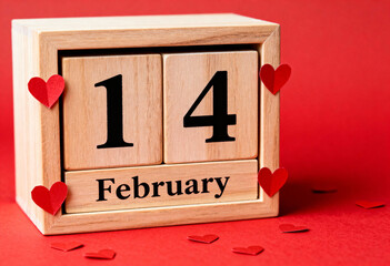 Wooden calendar displaying February 14 surrounded by red paper hearts, symbolizing Valentines Day holiday poster
