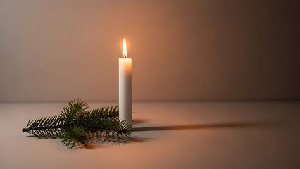 Single white candle burning next to a fir branch in dim light