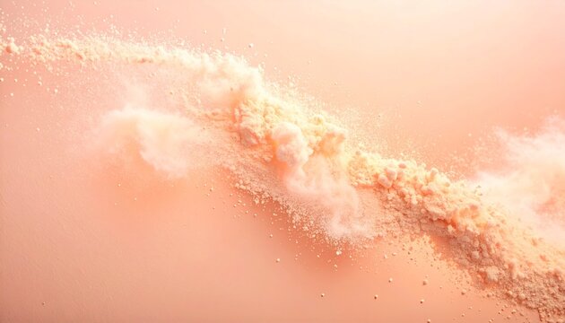 Fine cream or peach colored powder scatters dynamically across a pastel colored background. Textures vary from fine particles to tiny blobs, creating movement and a v-like effectd