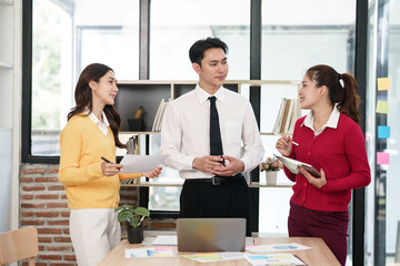 Group of Asian businesspeople sits down for a business investment planning meeting.