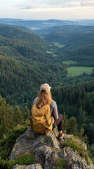 Naklejka premium Scenic mountain view with hiker overlooking lush valleys and forests during sunset in nature's tranquility