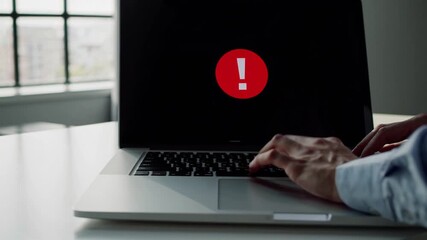 Focused professional working on a laptop in a modern office during daylight hours