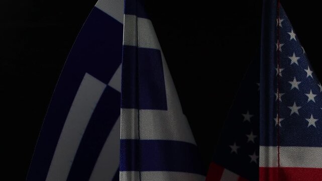 ​Close-up of the Flags of USA and Greece in rotation.

