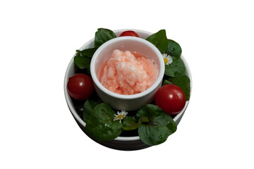 A close-up view of a refreshing fruit dessert, surrounded by fresh ingredients. The bowl is filled with vibrant colors and textures