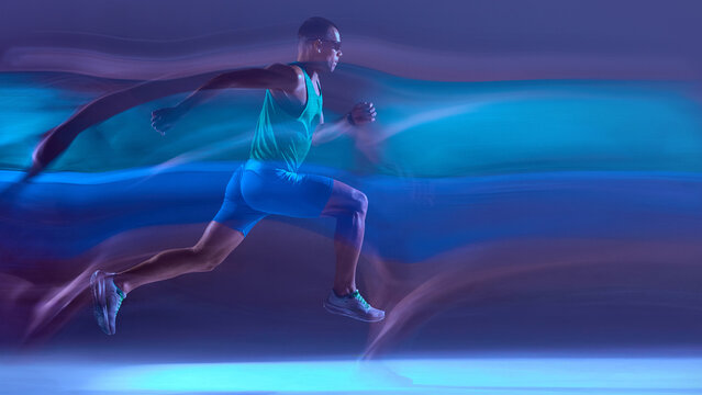Runner captured mid-stride in neon lighting with dynamic motion trails. Concept of sports app UI visuals, biomechanics education, sprint technique breakdowns, athlete branding materials.
