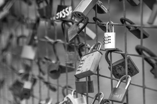 Love padlocks placed on a railing in the city centre.