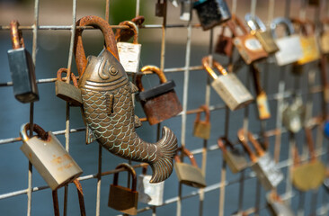 Love padlocks placed on a railing in the city centre.