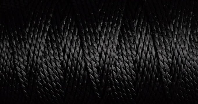 Seamless Woven Texture Background Loop. Texture of Dark rough twine. Video presenting a continuous dark gray woven thread texture.