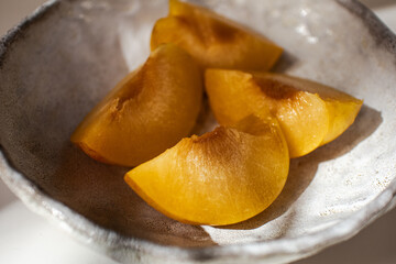 Peach on a plate. Pieces of fresh juicy peach on a plate.