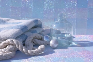 sparkling plaid blanket with braided rope, shiny foil, painted glass with snowy backdrop.