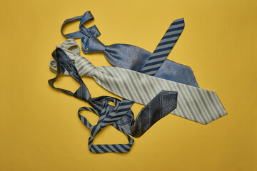 A collection of ties on a yellow background