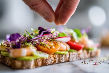 Foods styling magazine content concept. Fresh gourmet dish with vibrant toppings being delicately prepared.