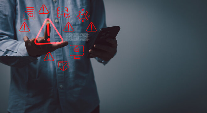 User holding smartphone with red digital warning icons, representing cybersecurity risks, system alerts, data breaches, and online threat detection modern mobile technology