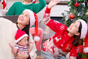 A young woman and her family happily celebrating Christmas or New Year, smiling with joy.