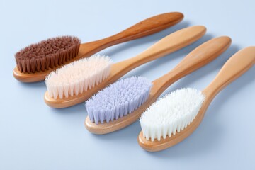 Four wooden brushes with different colors and sizes