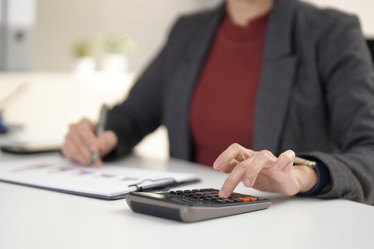 Senior business executive calculating financial data analyzing market trends planning company strategy office workspace reviewing reports budget management - Powered by Adobe