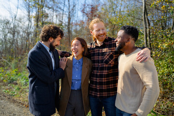 Friends enjoy time together outdoors in nature during a sunny day in the fall