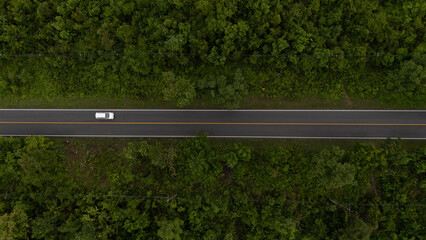 Aerial video of a rural road near a mountain with morning mist in Thailand.