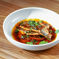 Gourmet Pan-Fried Fish Fillet with Spicy Red Sauce and Fresh Herbs