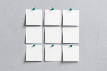 blank paper on a wall with green pins