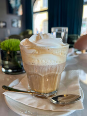 Coffee with Whipped Cream in Cozy Cafe