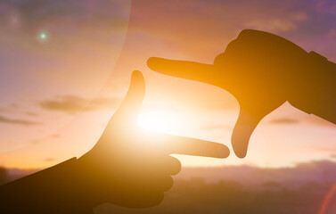 Framing the Sunset Through Creative Hands Silhouette