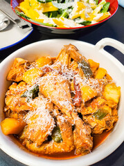 Korean spicy chicken stew topped with grated cheese as a homemade meal 