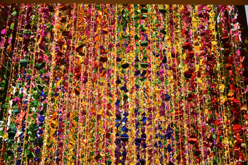Texture and background of Plastic hanging with strings, illuminated with colored lights, sparkling and beautiful for Christmas day decorations.