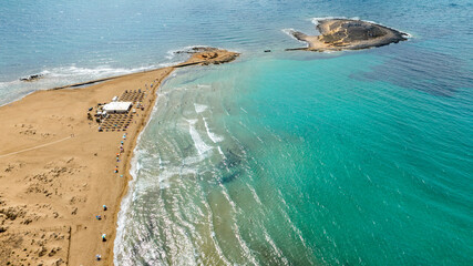 Aerial view of the southernmost Italian beach. It is located near Portopalo in the province of Syracuse, Sicily, Italy. In the background is Isola delle Correnti, a small rocky island near the coast.
