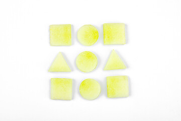 Geometric pattern of fresh melon pieces cut into squares, circles, triangles. Abstract food design