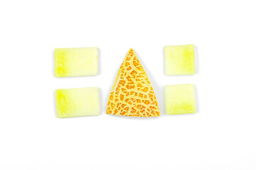 Geometric pattern of fresh melon pieces cut into squares, circles, triangles. Abstract food design