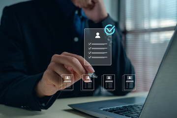 business professional reviewing digital user profiles and checklists on a laptop, representing workflow automation, online verification, document management, and efficient data processing.