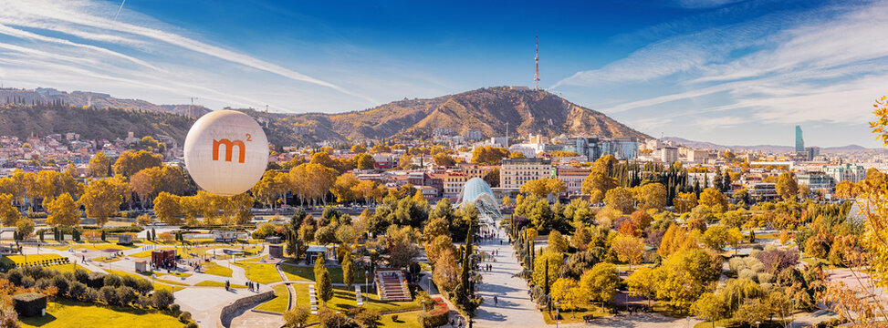 31 October 2025, Tbilisi, Georgia: Panoramic view of Rike Park with golden autumn trees creating a vibrant cityscape