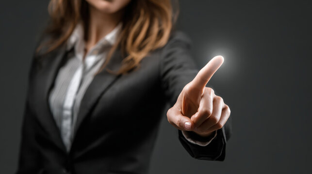 Businesswoman finger pointing touch screen gesture technology interface suit office innovation focus confident energy - Powered by Adobe