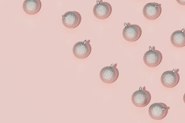  Top view of silver baubles on soft pink background